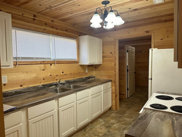 kitchen featuring sink, wood walls, wood ceiling, decorative light fixtures, and white fridge