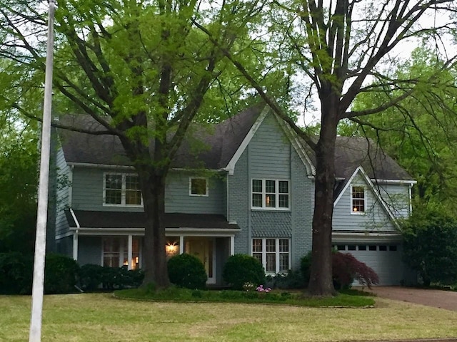 view of front of property with a garage and a front yard