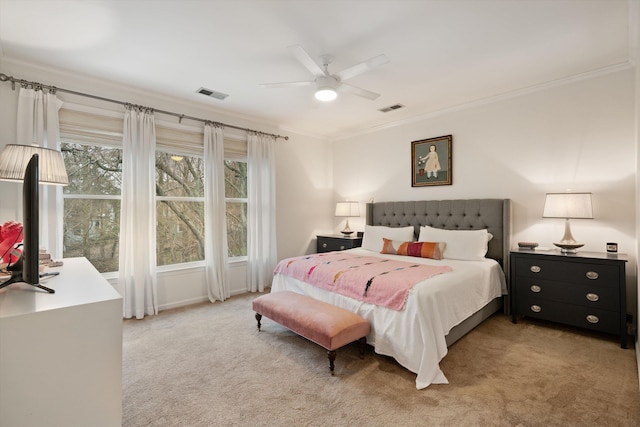 carpeted bedroom featuring ornamental molding and ceiling fan