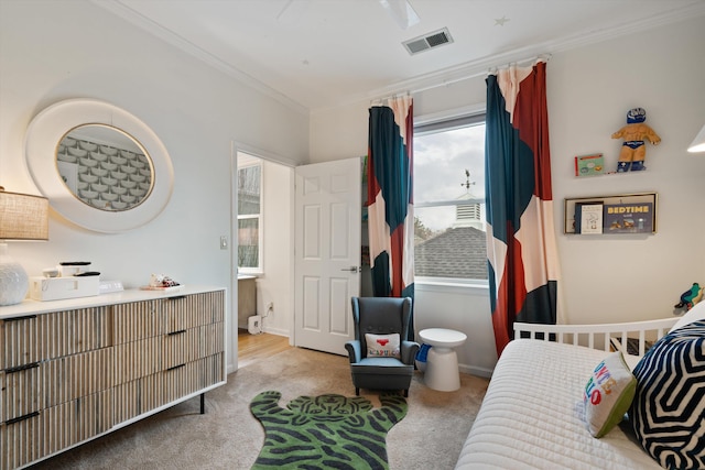 carpeted bedroom with ornamental molding