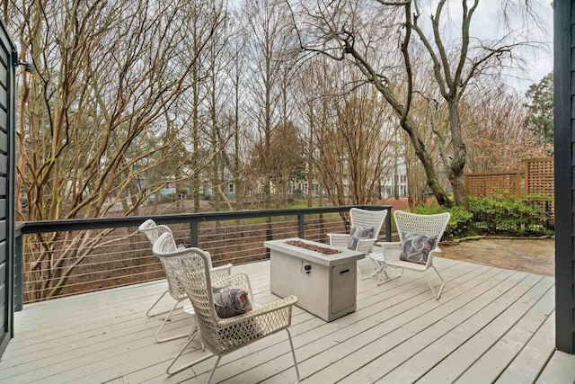 wooden deck featuring an outdoor fire pit