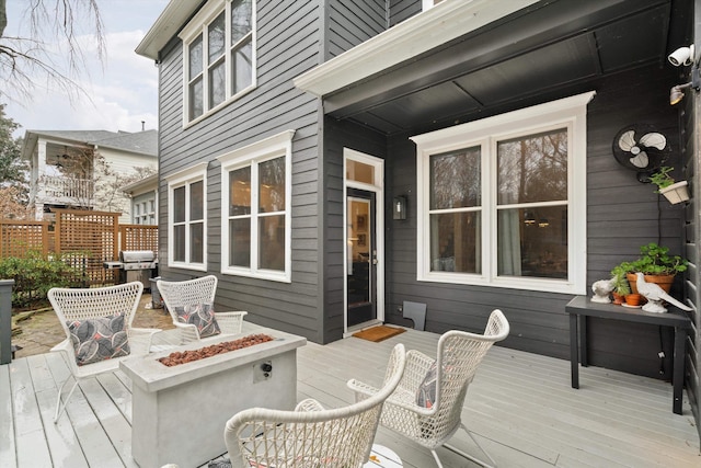 deck with a grill and an outdoor fire pit