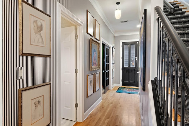 corridor with crown molding and light hardwood / wood-style floors