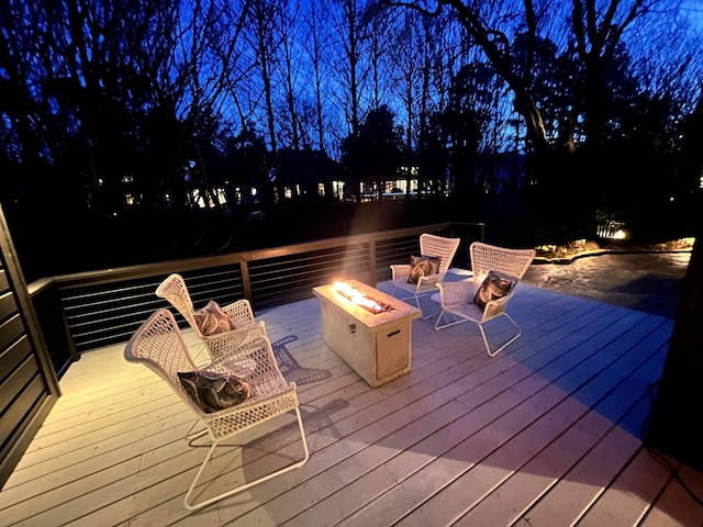 deck at twilight with a fire pit