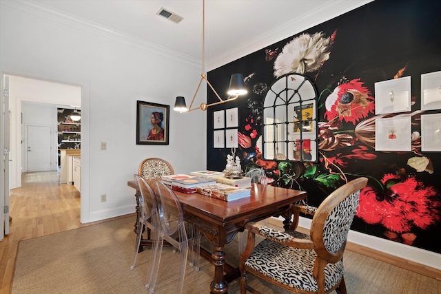 dining room featuring crown molding and hardwood / wood-style floors