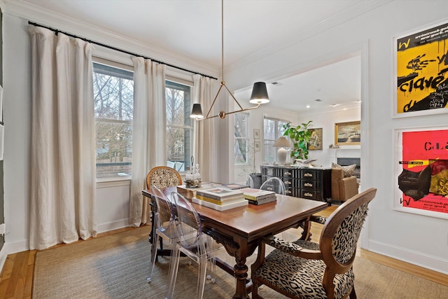 dining space with crown molding and wood-type flooring