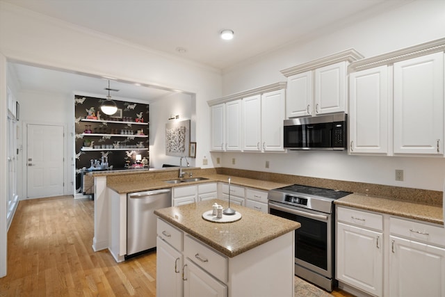 kitchen with a kitchen island, appliances with stainless steel finishes, sink, and kitchen peninsula