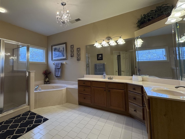 bathroom featuring tile patterned flooring, shower with separate bathtub, vanity, and a chandelier