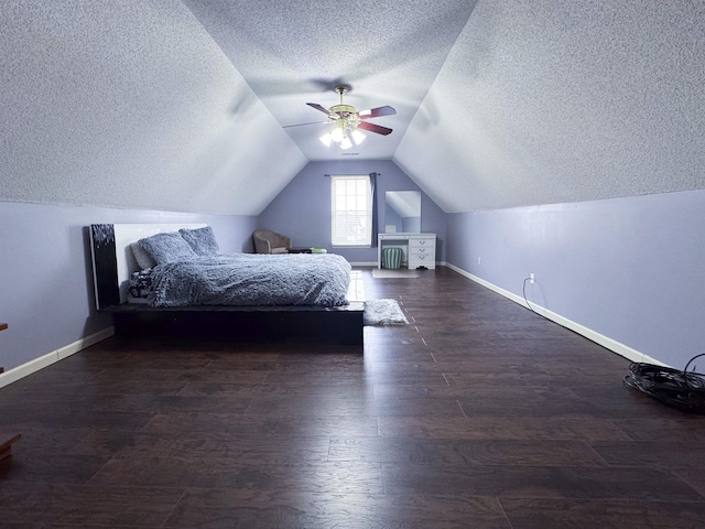 unfurnished bedroom with ceiling fan, lofted ceiling, dark hardwood / wood-style floors, and a textured ceiling