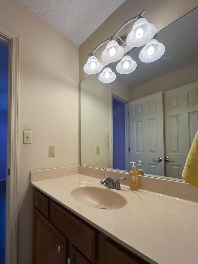 bathroom with vanity and a textured ceiling