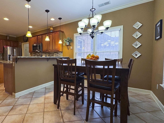 tiled dining area with ornamental molding and an inviting chandelier