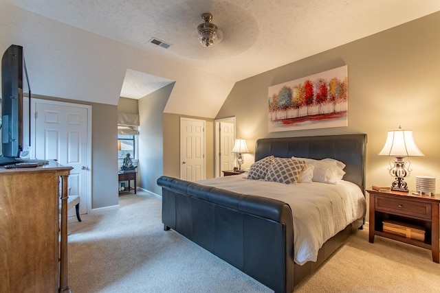 carpeted bedroom with vaulted ceiling, ceiling fan, and a textured ceiling