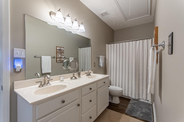 bathroom featuring toilet, a textured ceiling, vanity, a shower with shower curtain, and hardwood / wood-style flooring