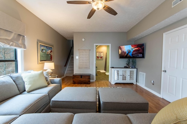 living room featuring hardwood / wood-style floors and ceiling fan