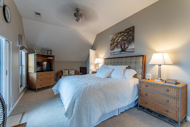 carpeted bedroom with lofted ceiling