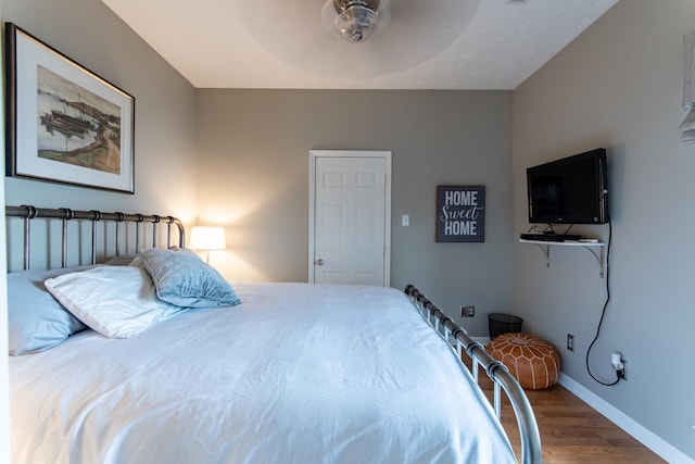 bedroom featuring hardwood / wood-style floors and ceiling fan