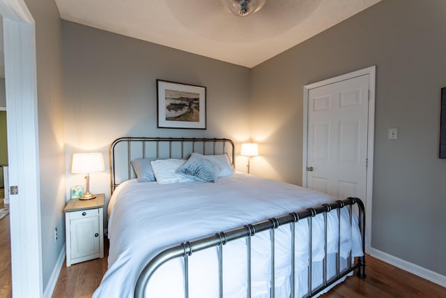 bedroom featuring dark wood-type flooring