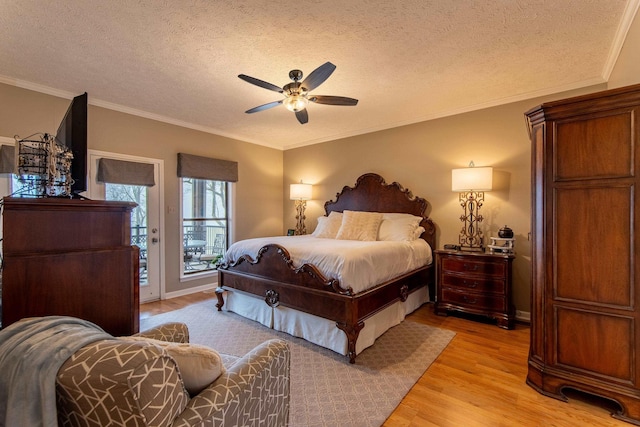 bedroom featuring access to exterior, ceiling fan, light hardwood / wood-style floors, crown molding, and a textured ceiling