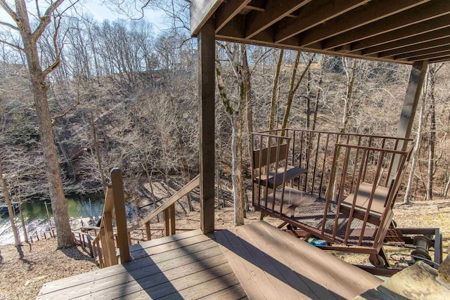 wooden terrace featuring a water view