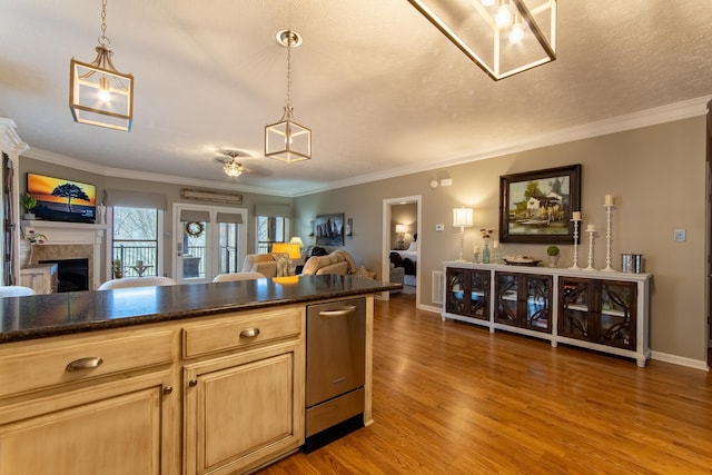 kitchen featuring pendant lighting, wood-type flooring, and ornamental molding