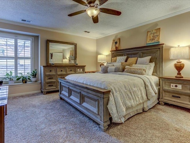 bedroom with crown molding, ceiling fan, carpet flooring, and a textured ceiling