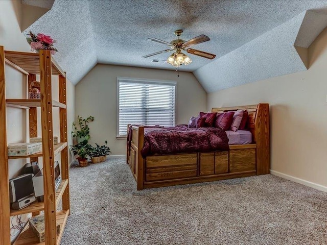 carpeted bedroom featuring ceiling fan, vaulted ceiling, and a textured ceiling