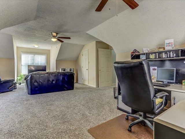 home office featuring vaulted ceiling, ceiling fan, carpet floors, and a textured ceiling