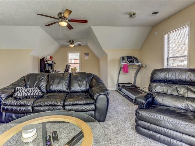 living room featuring vaulted ceiling, carpet flooring, ceiling fan, and a textured ceiling