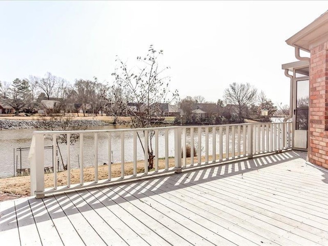 wooden terrace featuring a water view