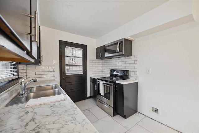 kitchen with sink, tasteful backsplash, and stainless steel appliances