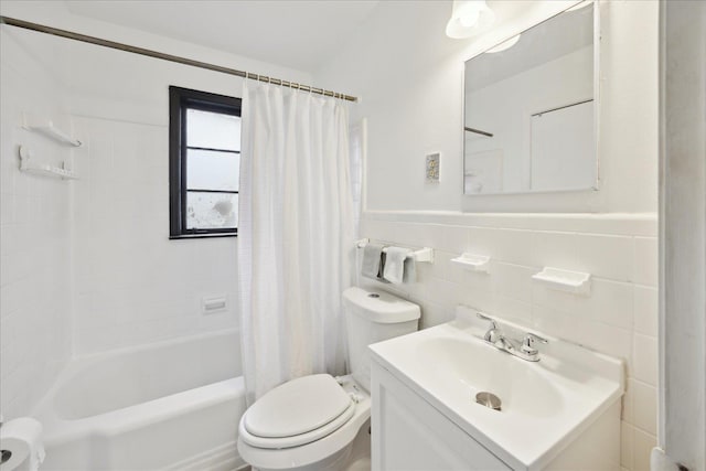 full bathroom featuring vanity, tile walls, toilet, and shower / tub combo