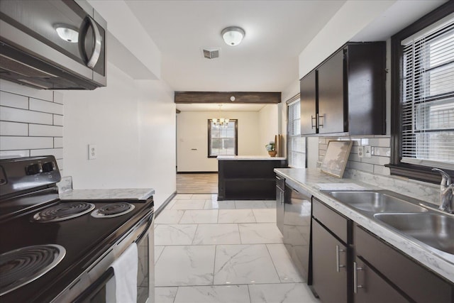 kitchen with sink, black dishwasher, electric range, and a healthy amount of sunlight