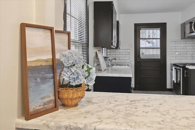 kitchen with sink, stainless steel appliances, and tasteful backsplash