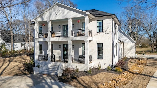 view of front of house with a porch and a balcony