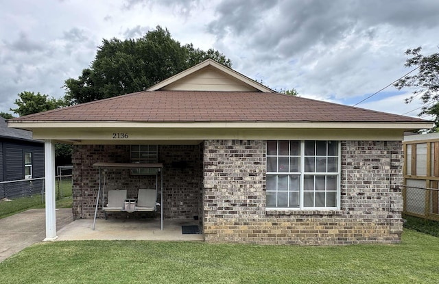 back of house featuring a yard and a patio