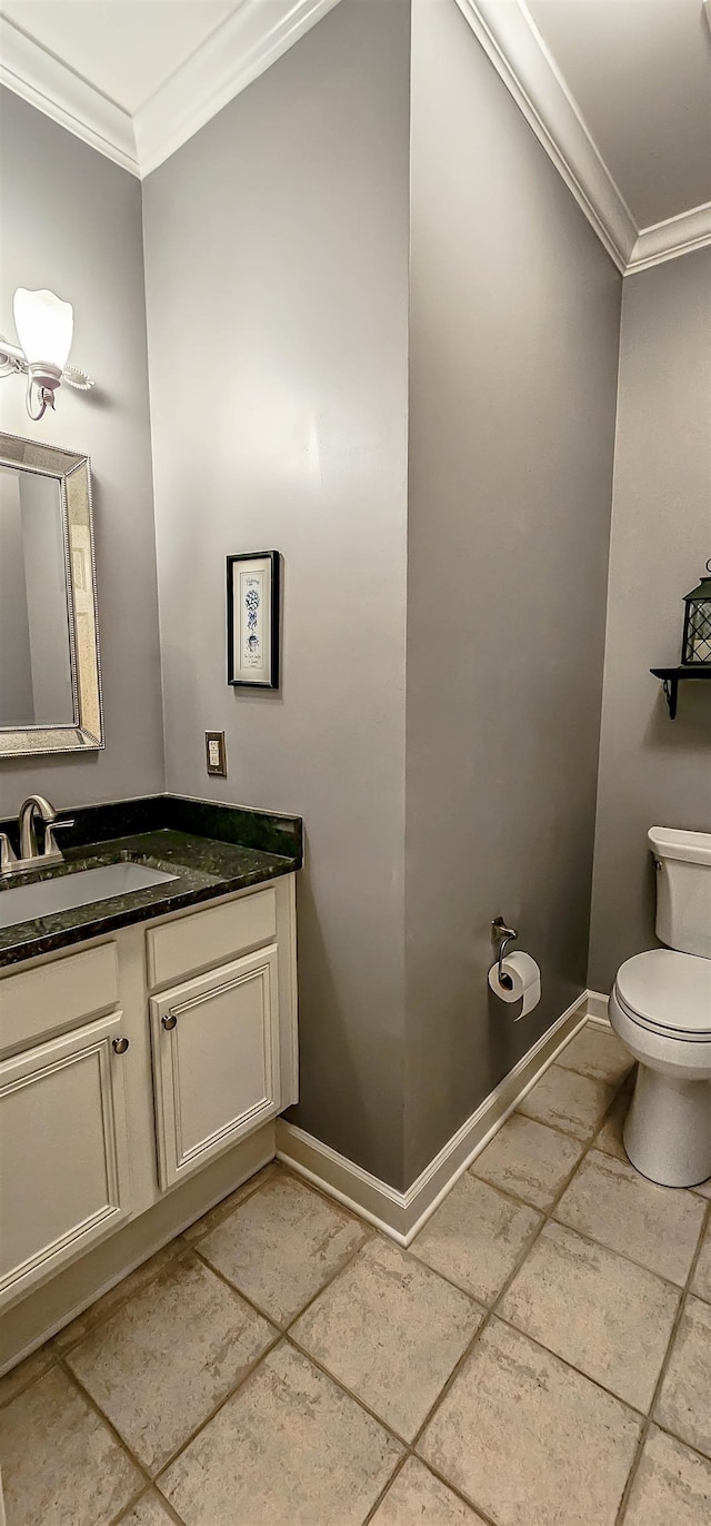 bathroom featuring ornamental molding, toilet, and vanity