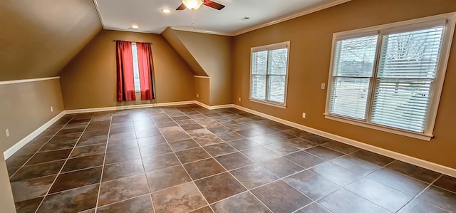 additional living space featuring ceiling fan, dark tile patterned flooring, and vaulted ceiling