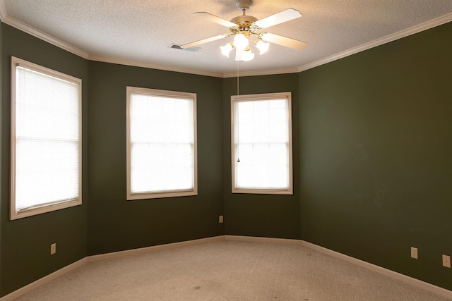 carpeted spare room with crown molding, ceiling fan, and a textured ceiling