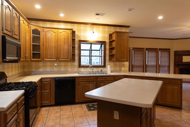 kitchen featuring light tile patterned flooring, sink, crown molding, a center island, and black appliances