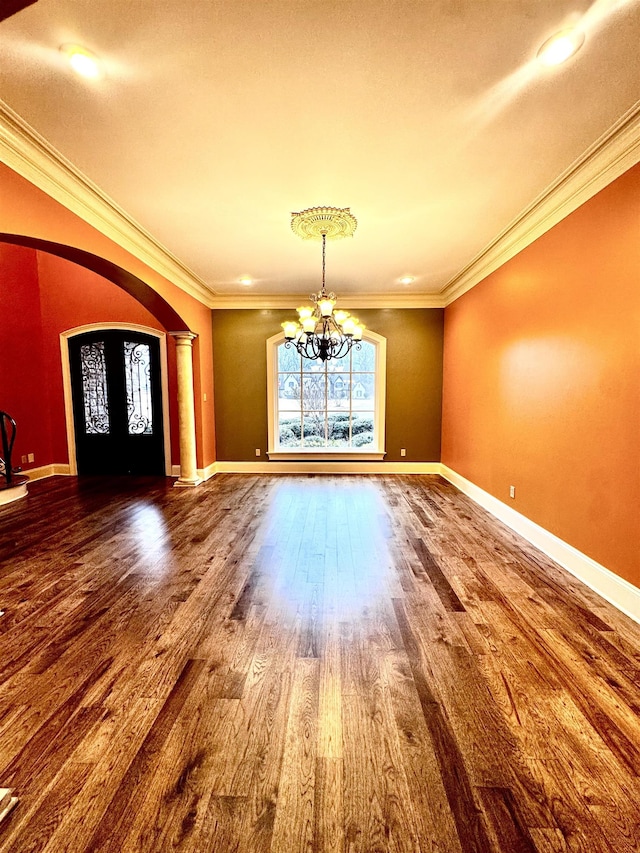 interior space with crown molding, hardwood / wood-style floors, and a chandelier