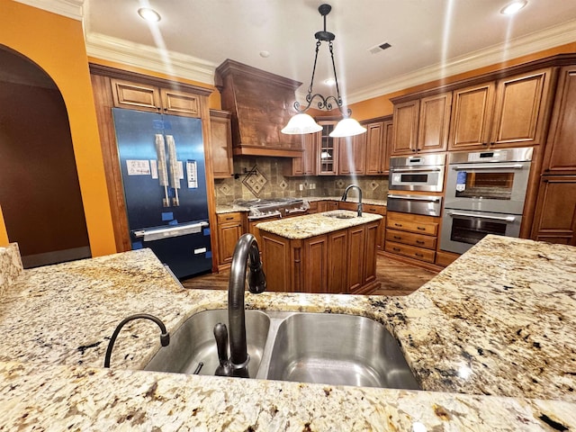 kitchen featuring sink, custom exhaust hood, hanging light fixtures, paneled built in refrigerator, and double oven