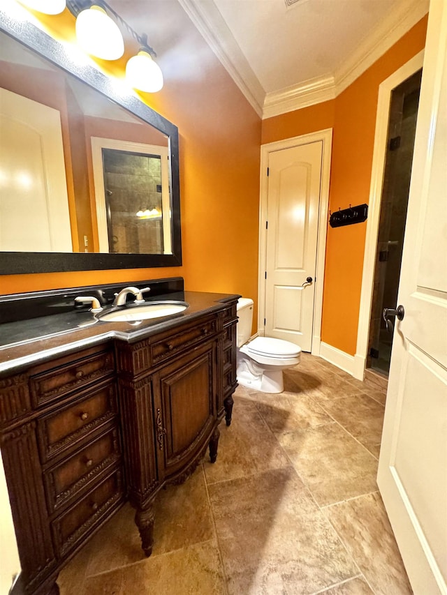 bathroom featuring ornamental molding, vanity, and toilet