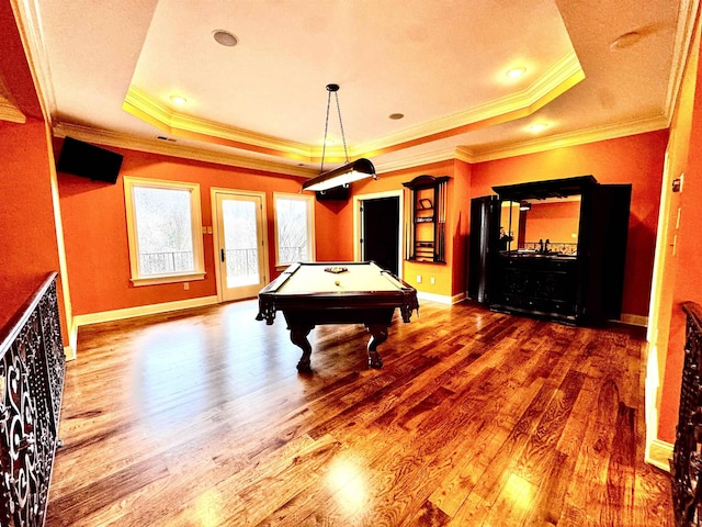 recreation room featuring crown molding, pool table, a raised ceiling, and hardwood / wood-style floors