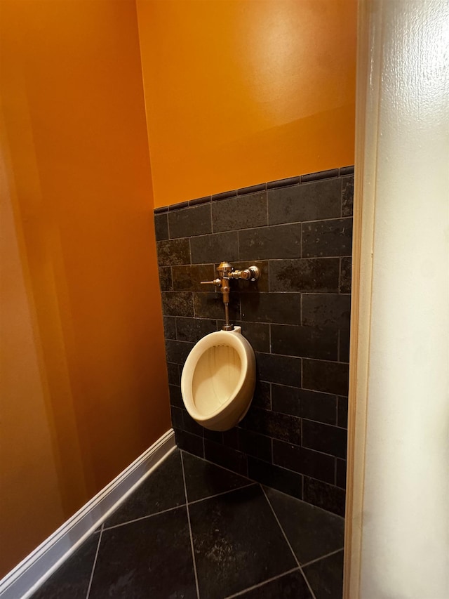 bathroom with tile patterned floors and tile walls