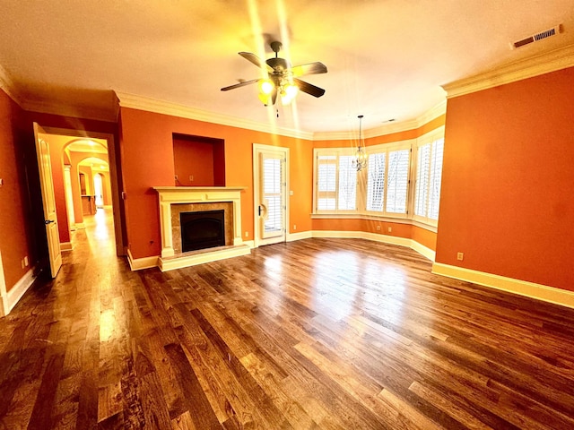 unfurnished living room featuring ceiling fan, ornamental molding, and dark hardwood / wood-style floors