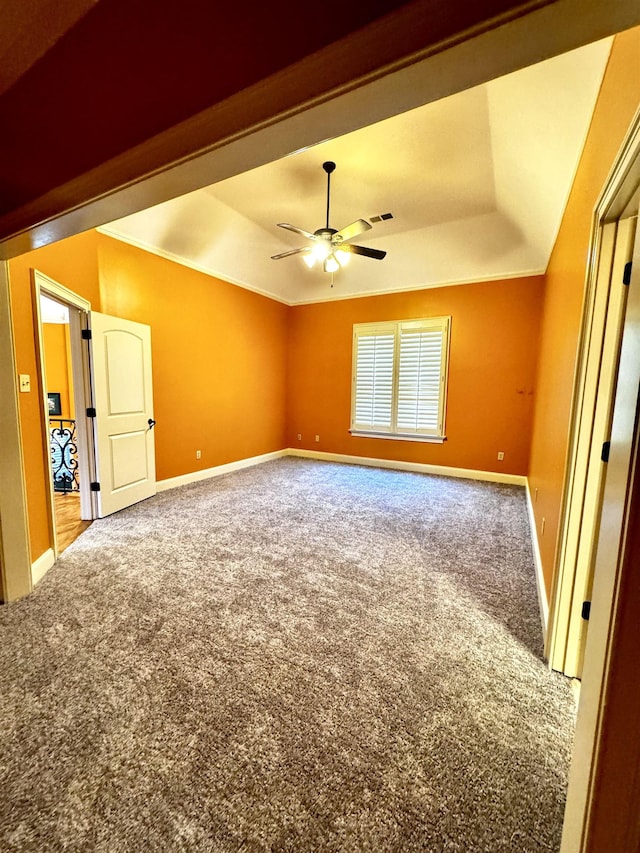 interior space with crown molding, a raised ceiling, and ceiling fan