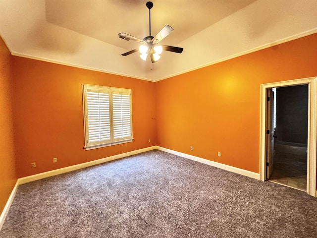 carpeted spare room with vaulted ceiling, crown molding, and ceiling fan