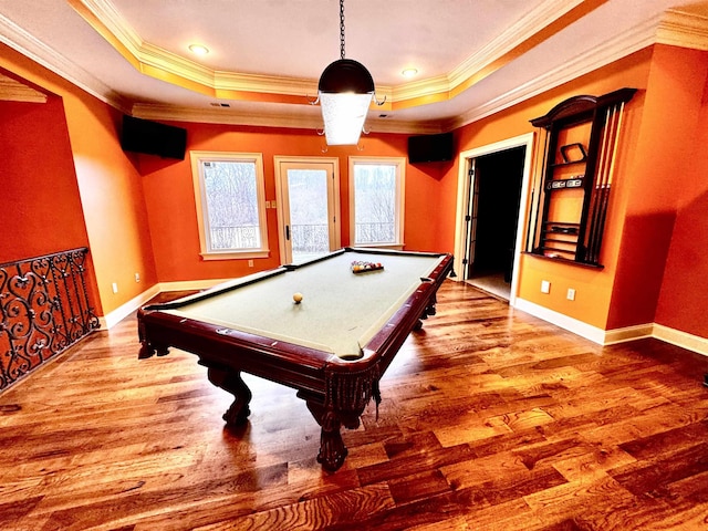 rec room with crown molding, a tray ceiling, and hardwood / wood-style floors