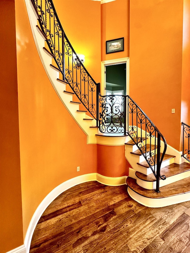 stairway featuring hardwood / wood-style flooring