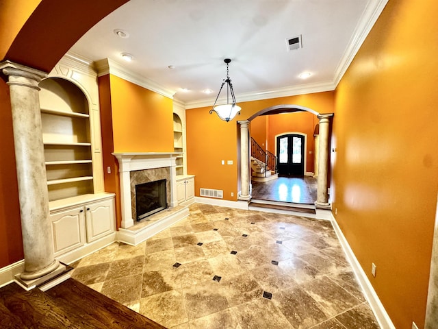 unfurnished living room with ornate columns, ornamental molding, built in features, and a high end fireplace